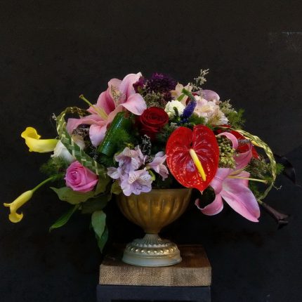 Golden cup with different flowers
